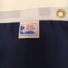 Texas Flag-up close of Made in USA tag, brass grommet and white heading