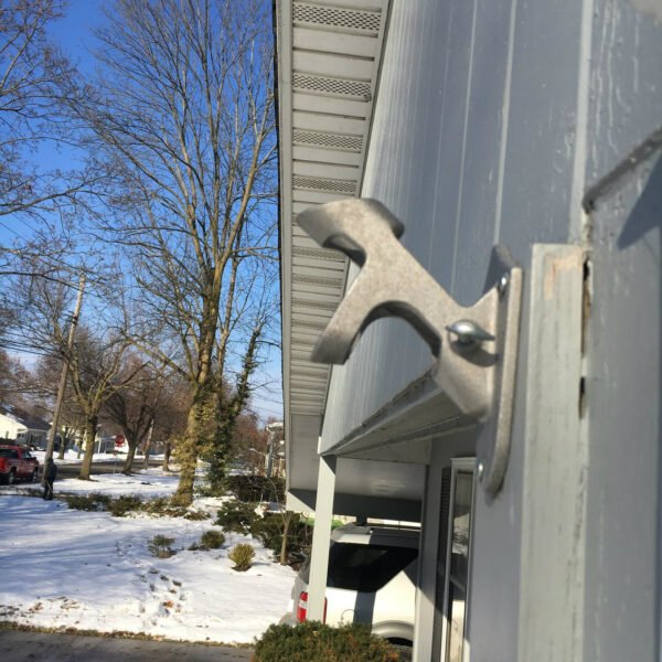 Silver Cast Aluminum 2-Position flag pole Bracket side view mounted on home. Made in U.S.A.