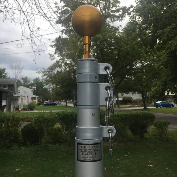 Titan Telescoping Flagpole-Down position showing the 3"Gold Ball, Lexan swivel ring harnesses, stainless steel clips. Made in USA