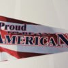 Tail end of pennant with the words Proud to be an American